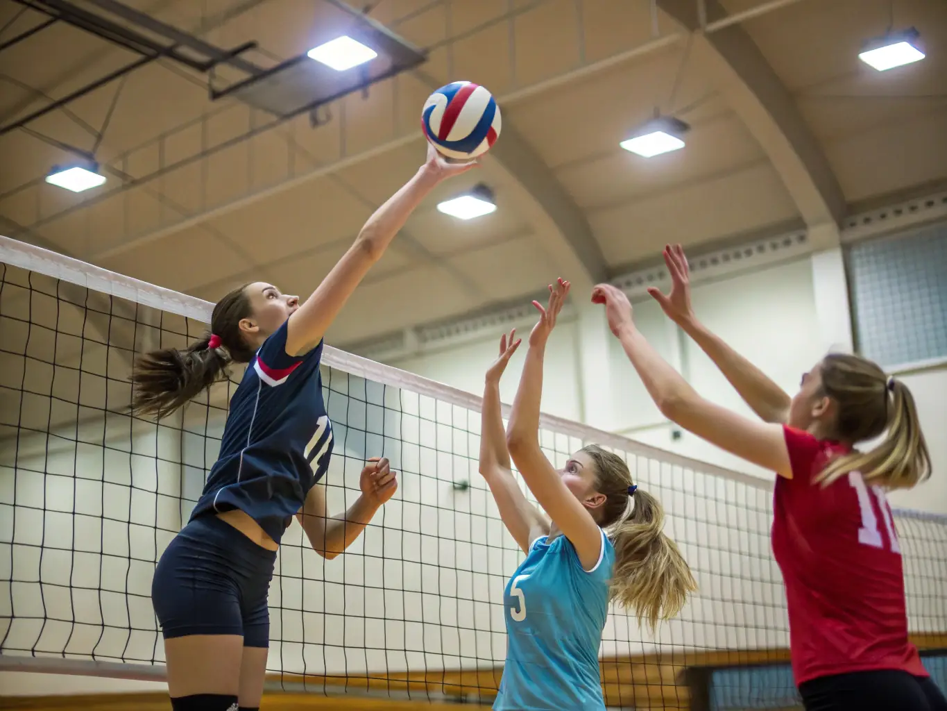 A dynamic image of students participating in a volleyball match, highlighting teamwork and communication.